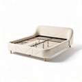Upholstered bed frame with wooden slats and soft fabric in cream color